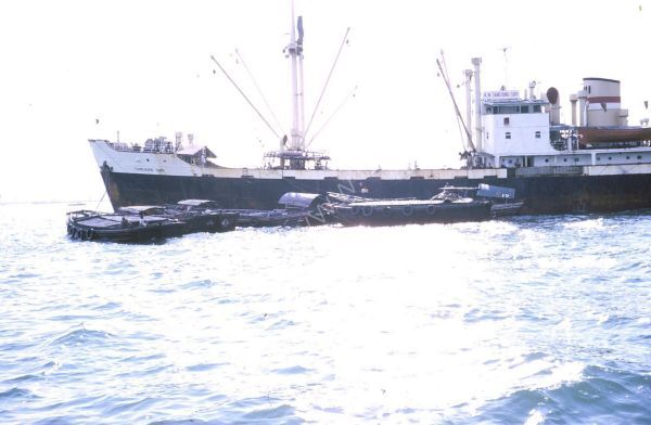 Sampans loading goods from a Ship, Singapore Harbour